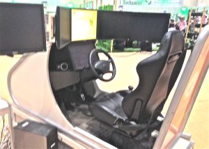 Driving simulator. Though some of the girls play video games, it's obvious they don't have driver's licenses.
